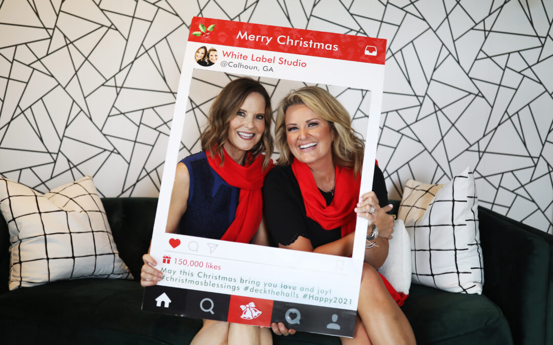 two women holding holiday social media frame