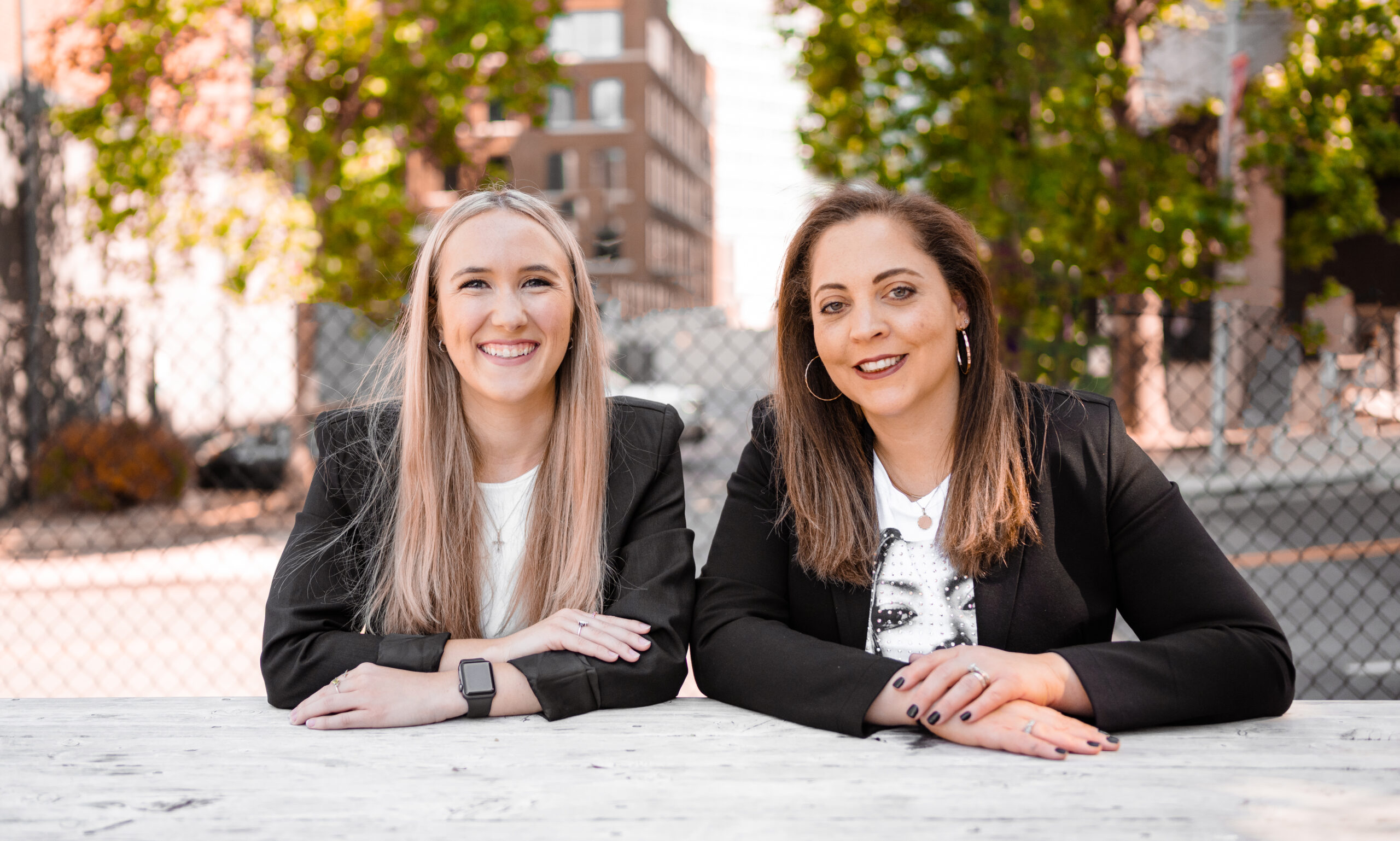 two business women with city background