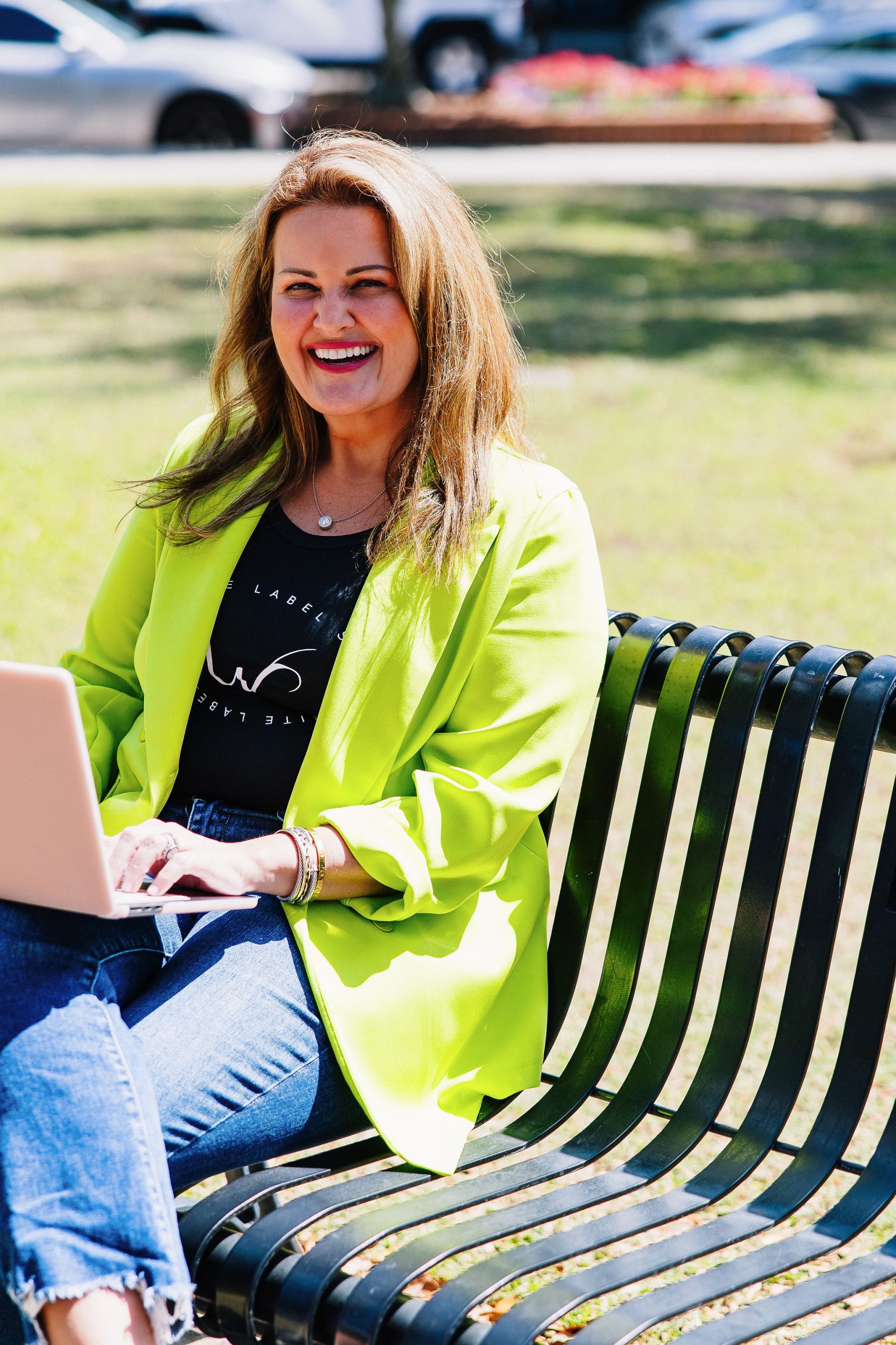Mollie Surratt, founder of White Label Studio, working outdoors on her laptop