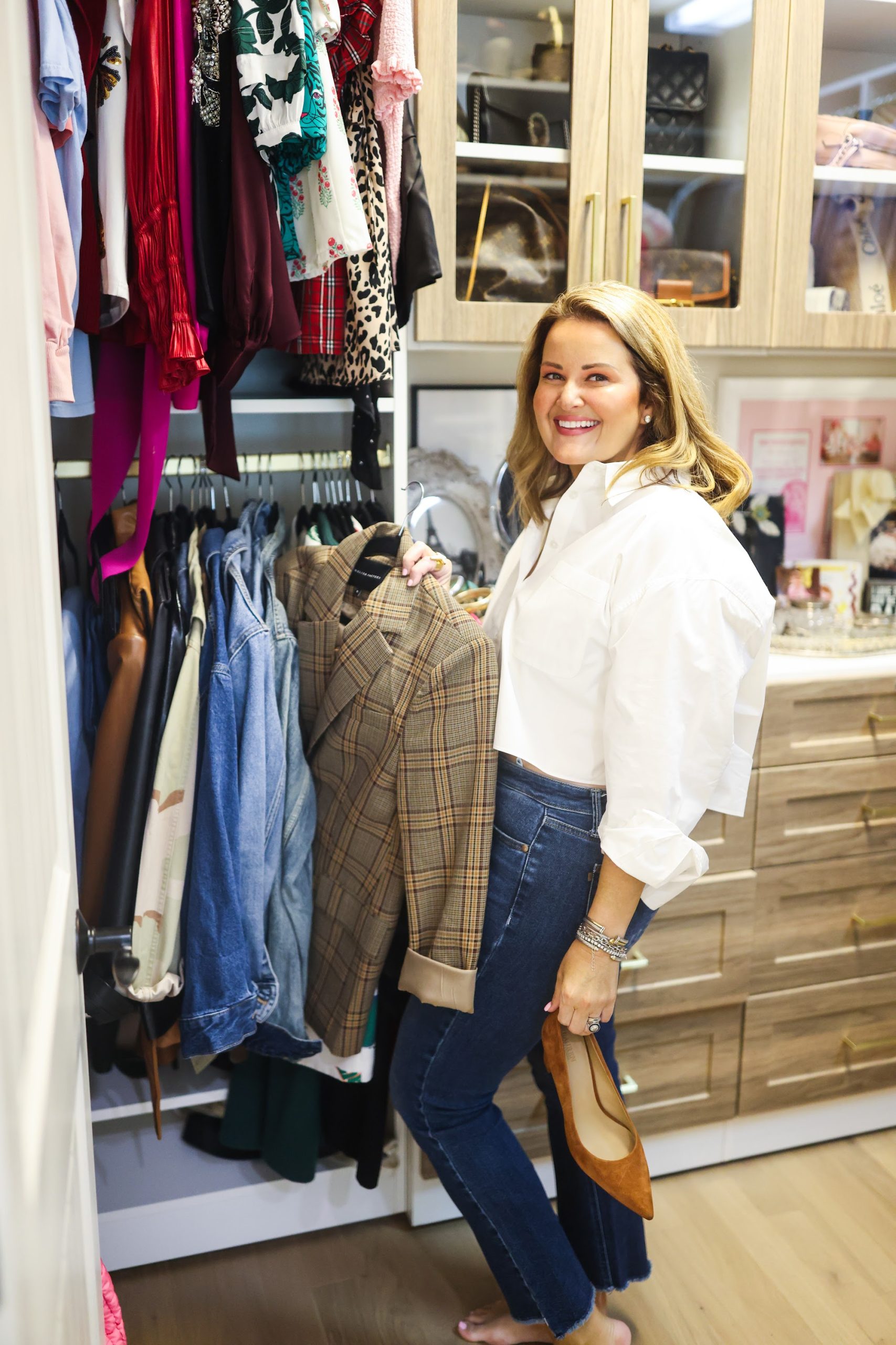 Mollie Surratt selecting an outfit from the custom closet system built with The Designery