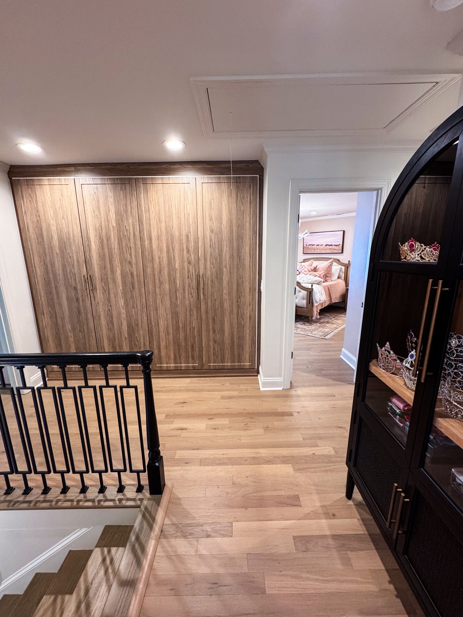 Upstairs hallway with the custom built-in locker wall beside the staircase